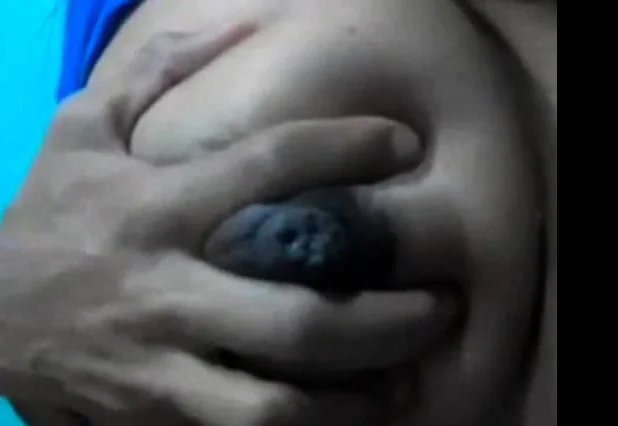 Squeezes out milk from her dark nip ttis