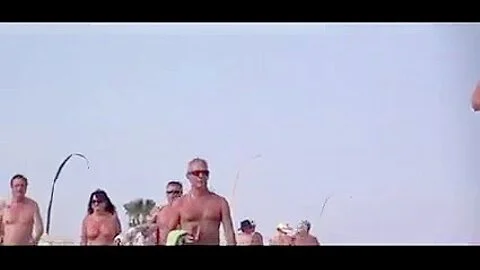 French nudist beach Cap d'Agde people walking in nature's garb 02