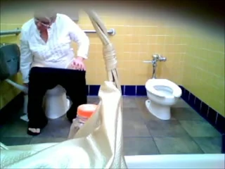 older woman in white with glasses