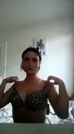 Girl strips and fingers her pussy