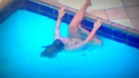 Woman playing with pool jet