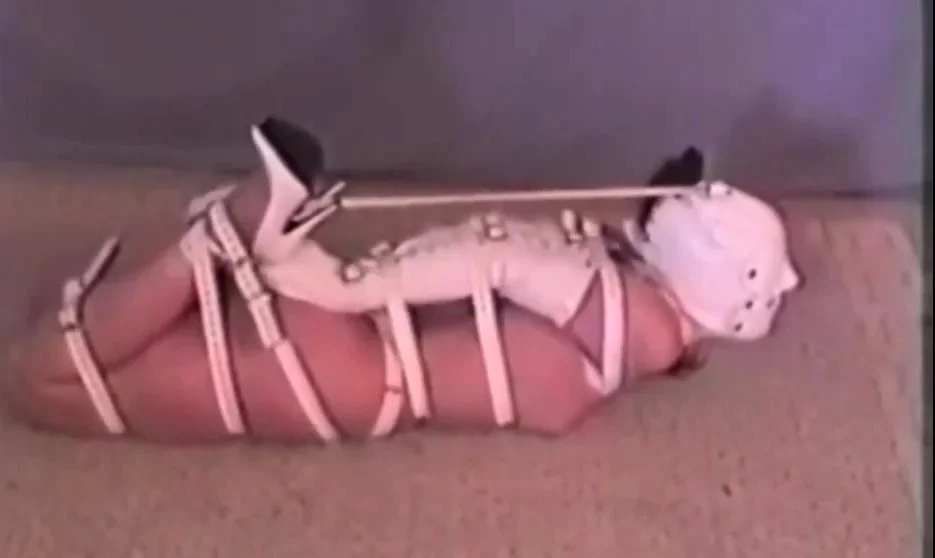 Hogtied Ashley struggling on the floor