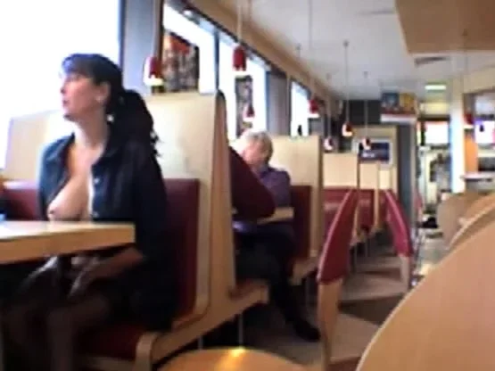 Busty babe flashing in a restaurant