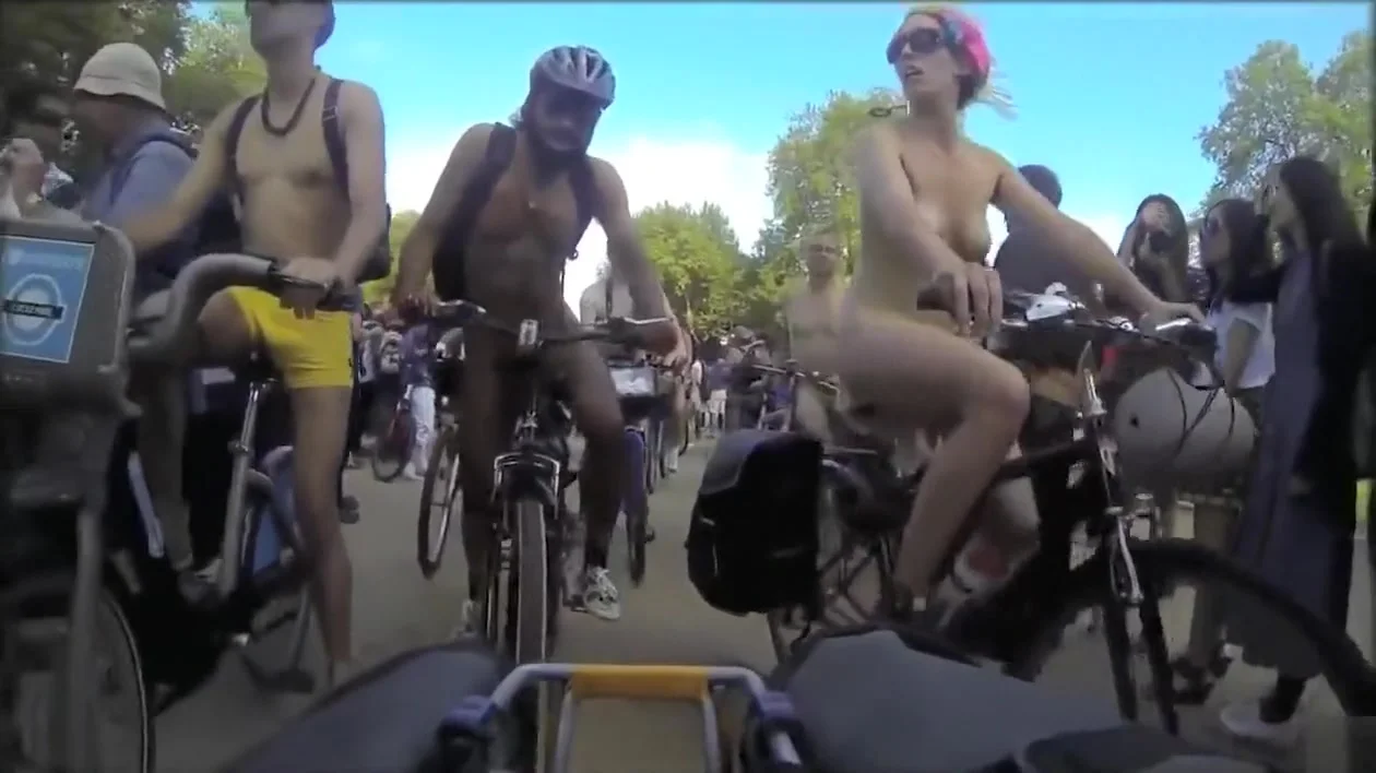 Group of nudists cycle through a town in their birthday suits